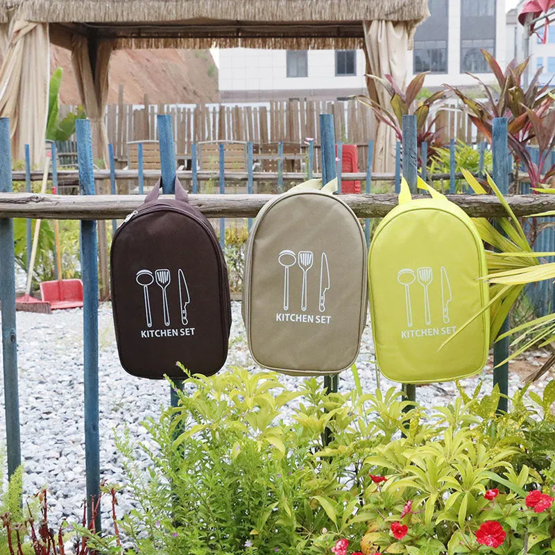 Portable picnic bag containing a 12-piece stainless steel kitchenware set.
