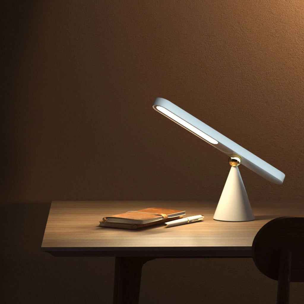 Geometric creative desk lamp with magnetic base shown in white on a desk.