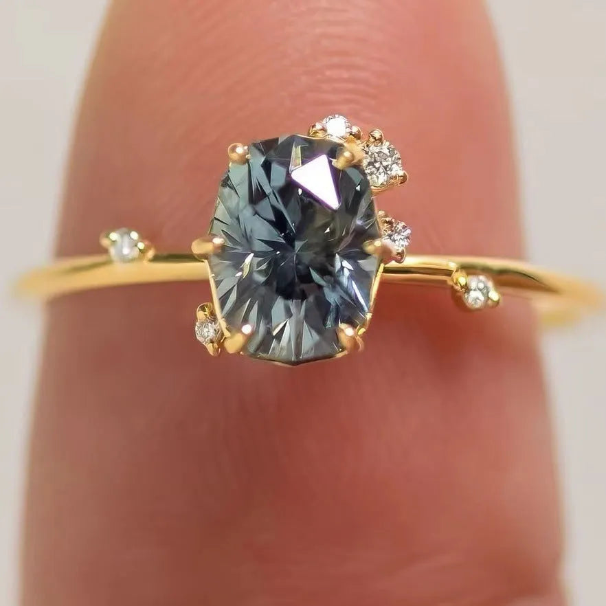 Gold plated floral-shaped women's ring with green zircon stones on an alloy band.