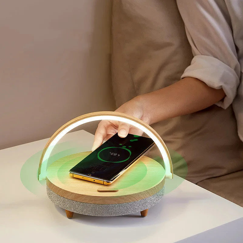 Marble pattern wireless charging night light with Bluetooth speaker and integrated phone holder.