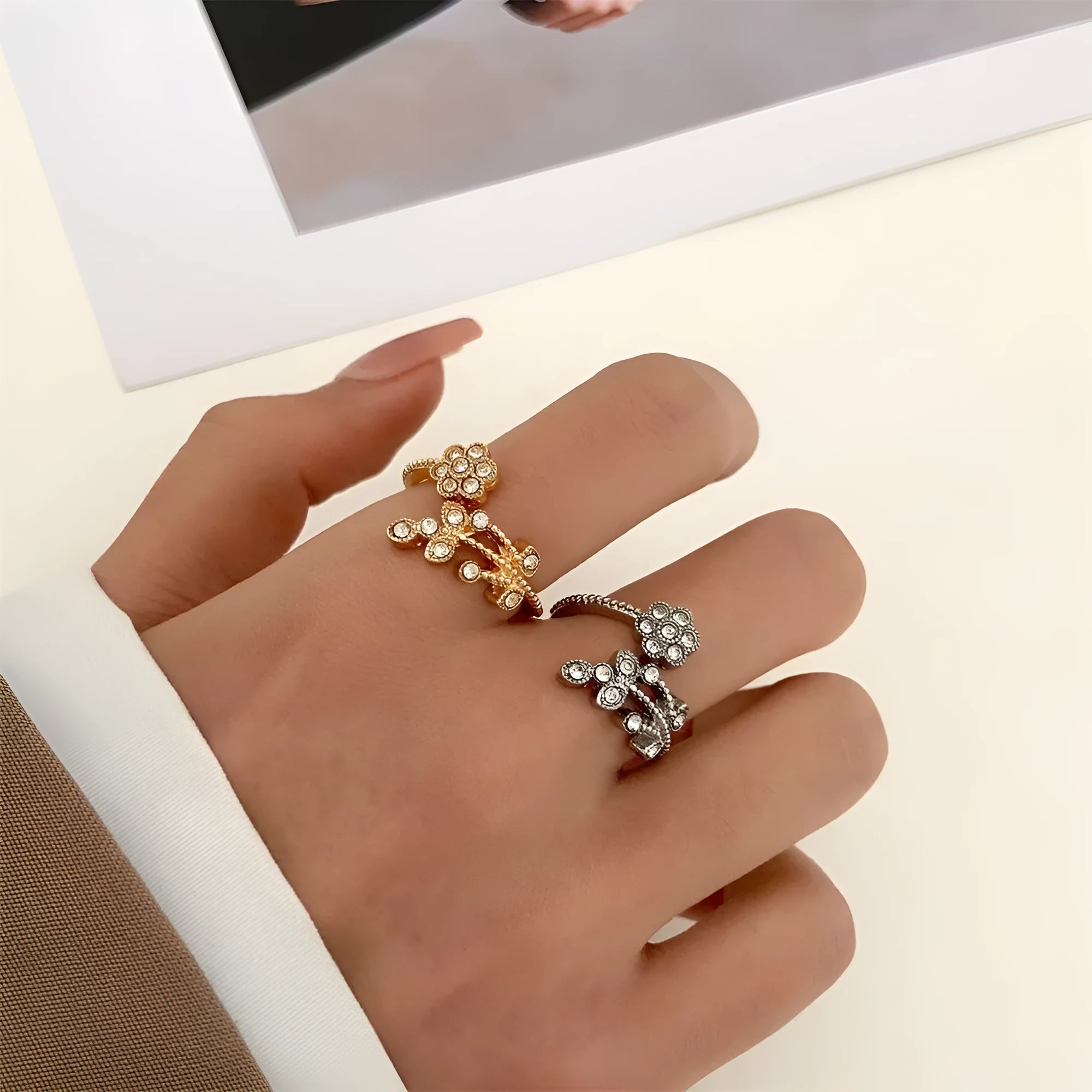 Women's open mouth copper ring with diamond-textured flower and leaves design in gold or white finish.
