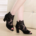 Black women's lace-up gladiator sandals with a square heel and zip fastener.