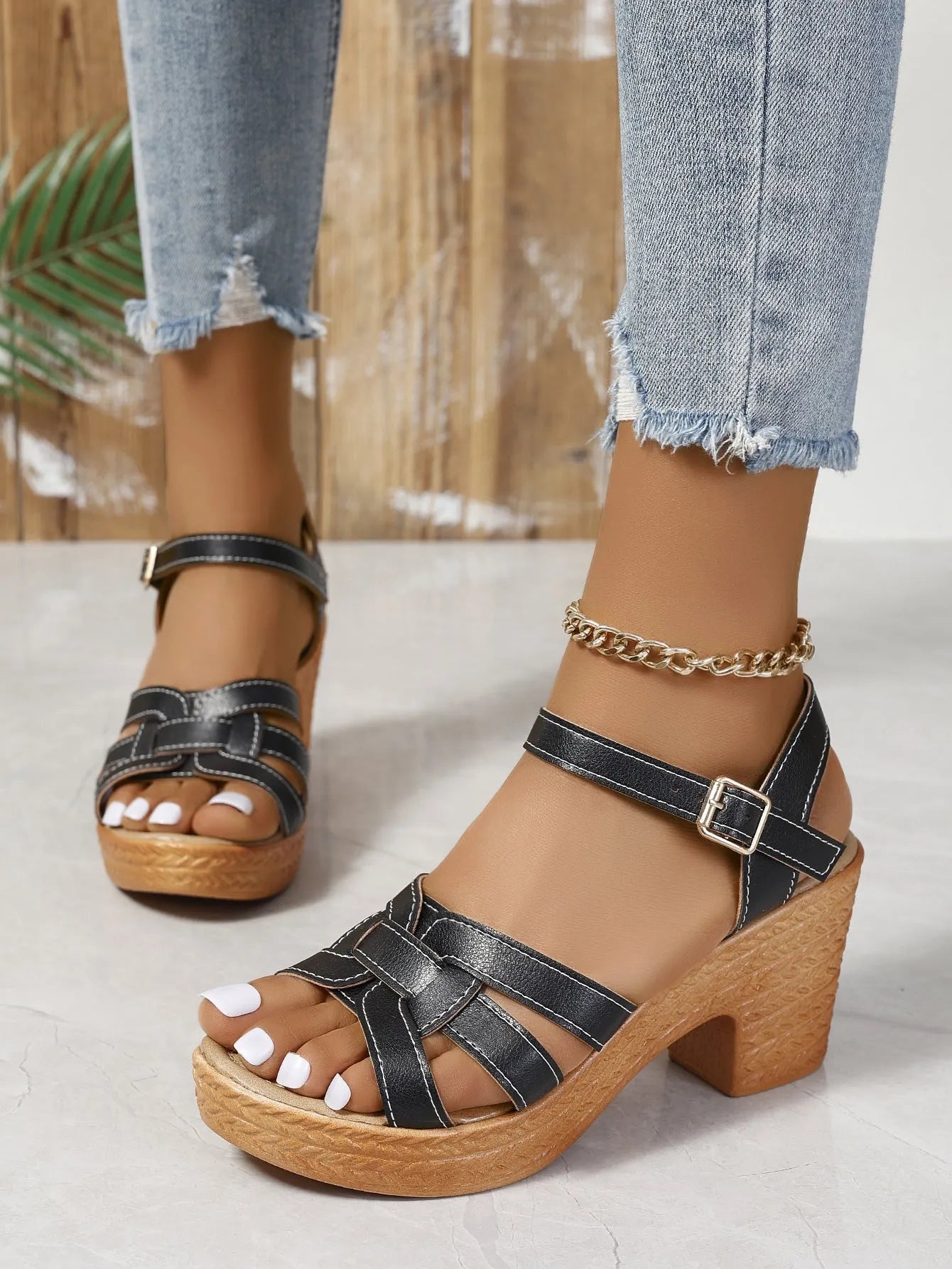 Plus size Roman peep toe chunky heel sandals with ankle buckle in black, brown, white options on display