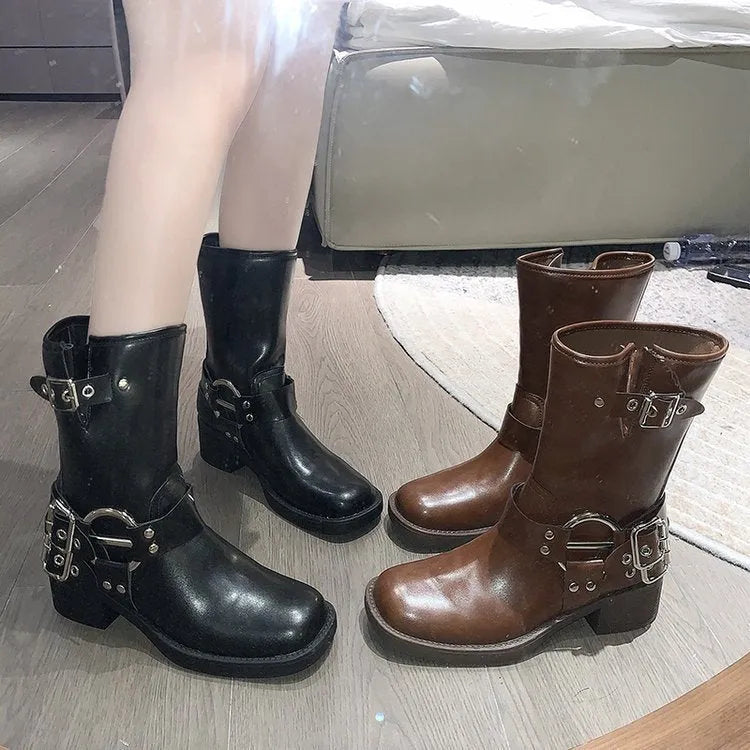 Black platform calf-length women's boots with a large decorative buckle on the shaft.