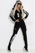 Black women's printed polyester hooded casual suit with zip top and matching trousers on a model