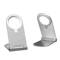 Silver vertical adjustable magnetic phone bracket for iPhone 12 models on a flat surface.