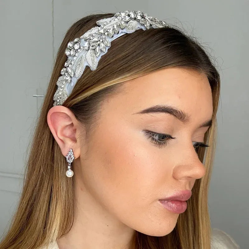 Geometric flower shaped earrings with micro inlaid zircon stones and pearl details on gold plating.