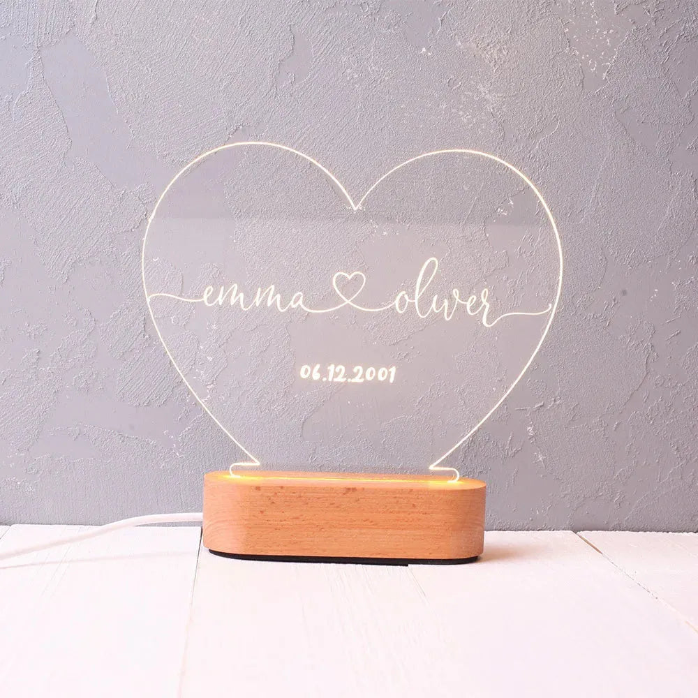 Custom acrylic LED night light with personalised names and dates illuminated