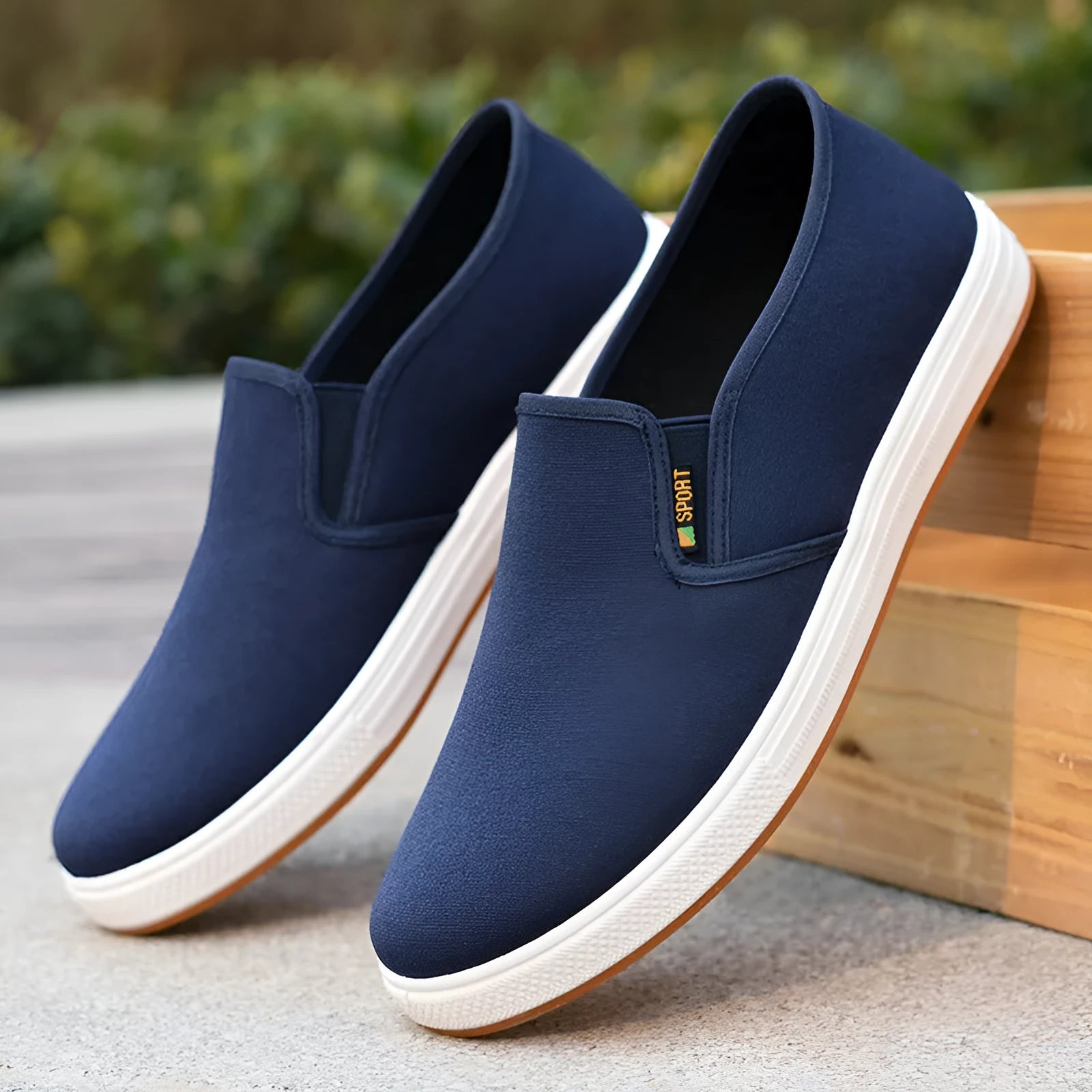 Men's low-top black and blue canvas slip-on shoes with round toe and shallow cut.