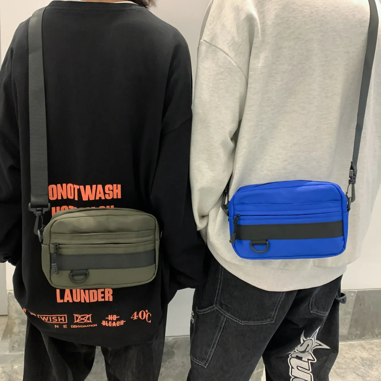 Men's nylon messenger bag in black showing street trend styling with sewing thread details and crossbody strap