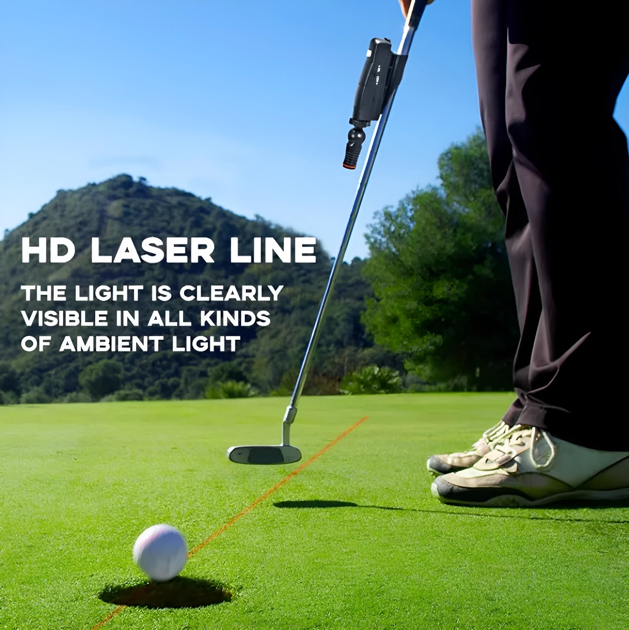 Black golf laser aiming instrument attached to a putter on a practice green