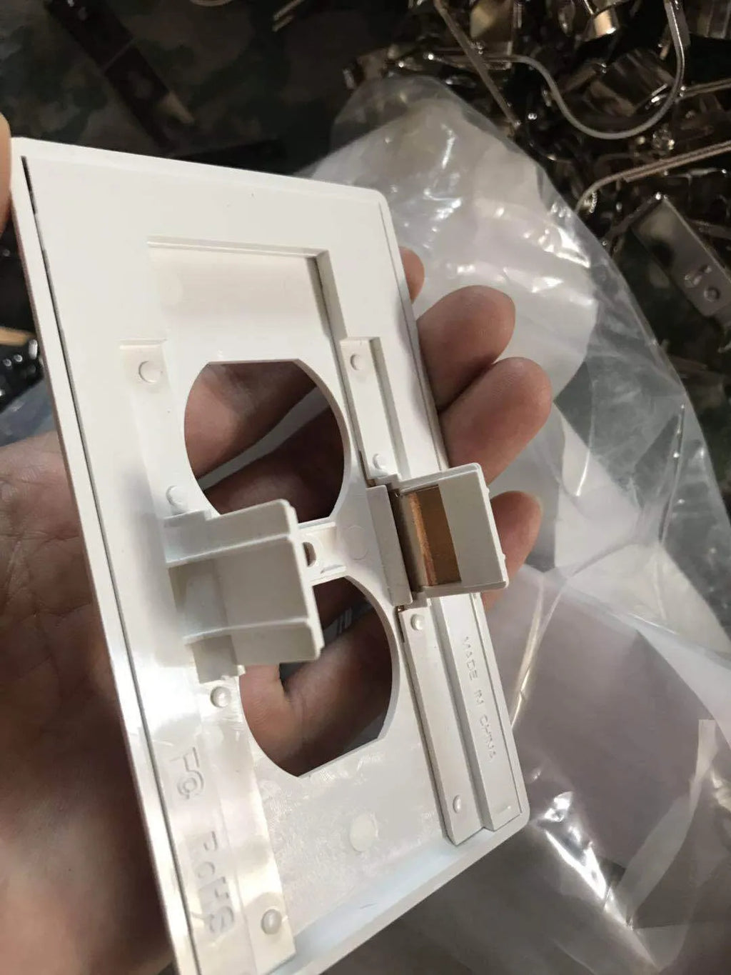 White plastic automatic LED night light plugged into a standard UK wall socket.