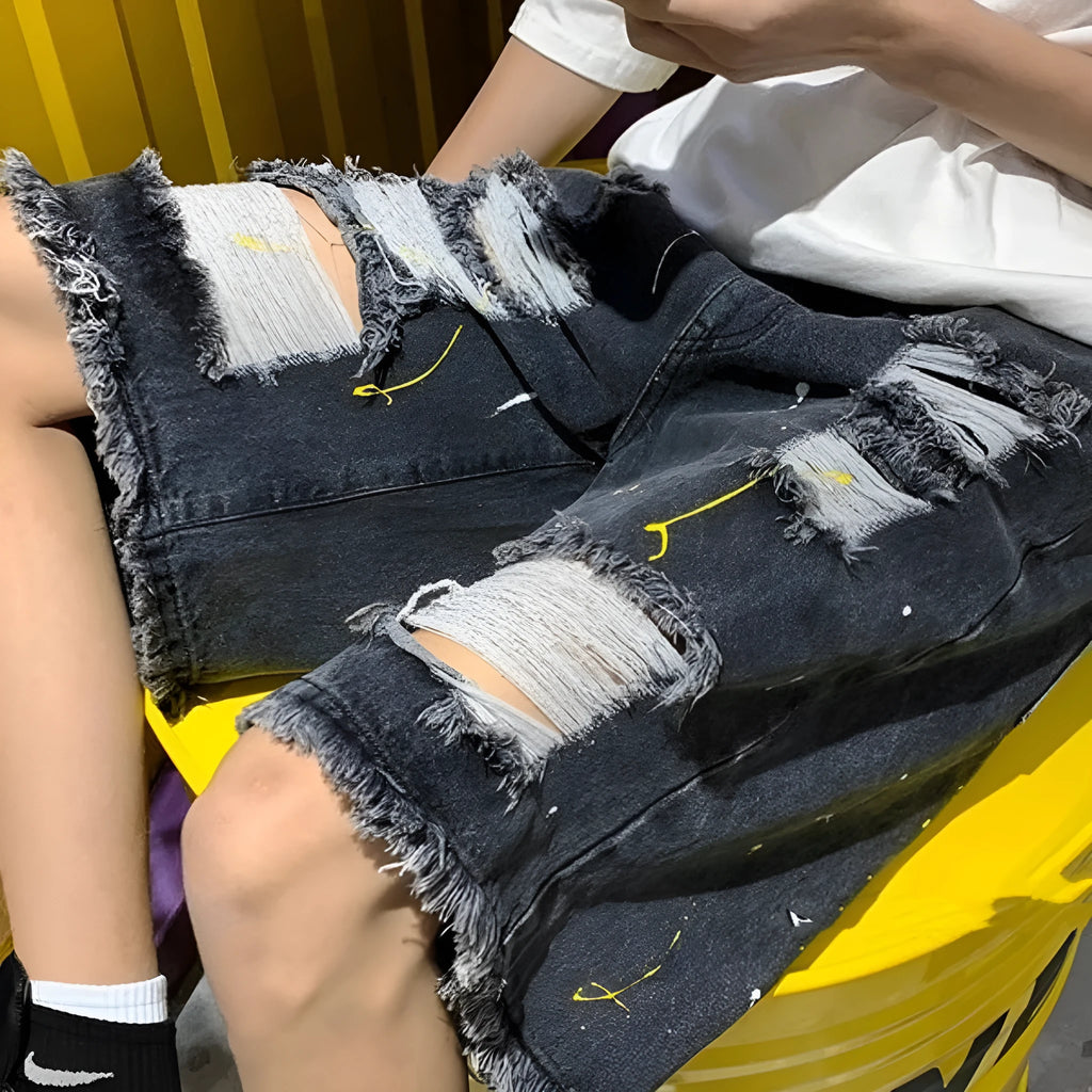 Men's distressed denim shorts with holes in light blue colour, loose fit above knee length