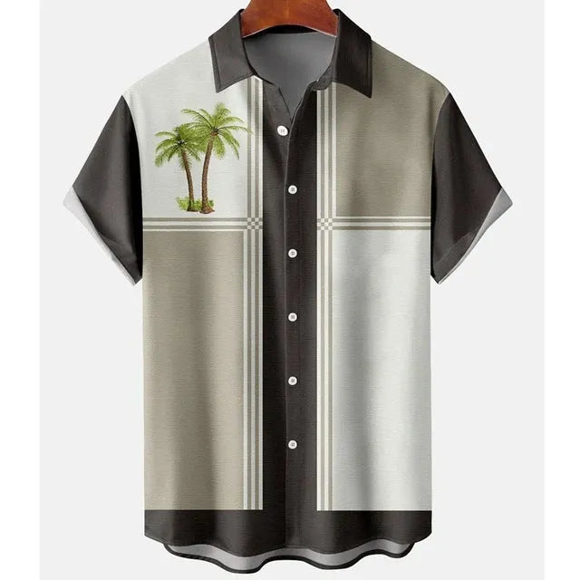 Man wearing a slim fit short sleeve shirt with a colourful 3D floral print, on a beach.