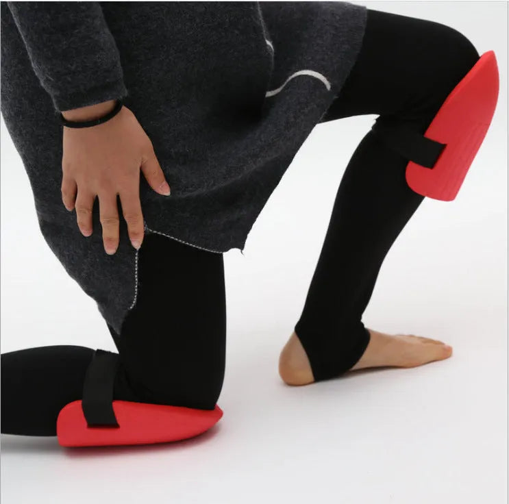 A pair of black EVA foam knee pads for gardening, showing their rectangular shape and thickness.