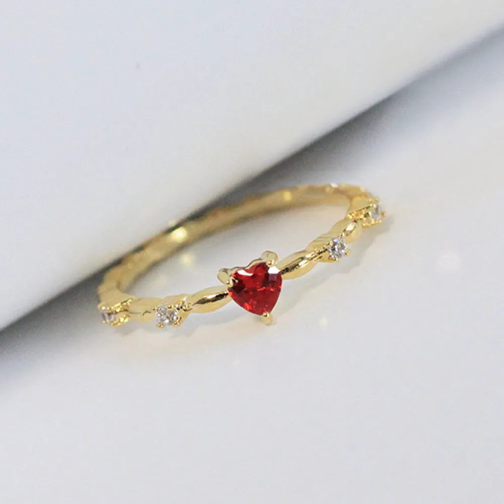Copper zircon peach heart ring in gold on hand, unisex size