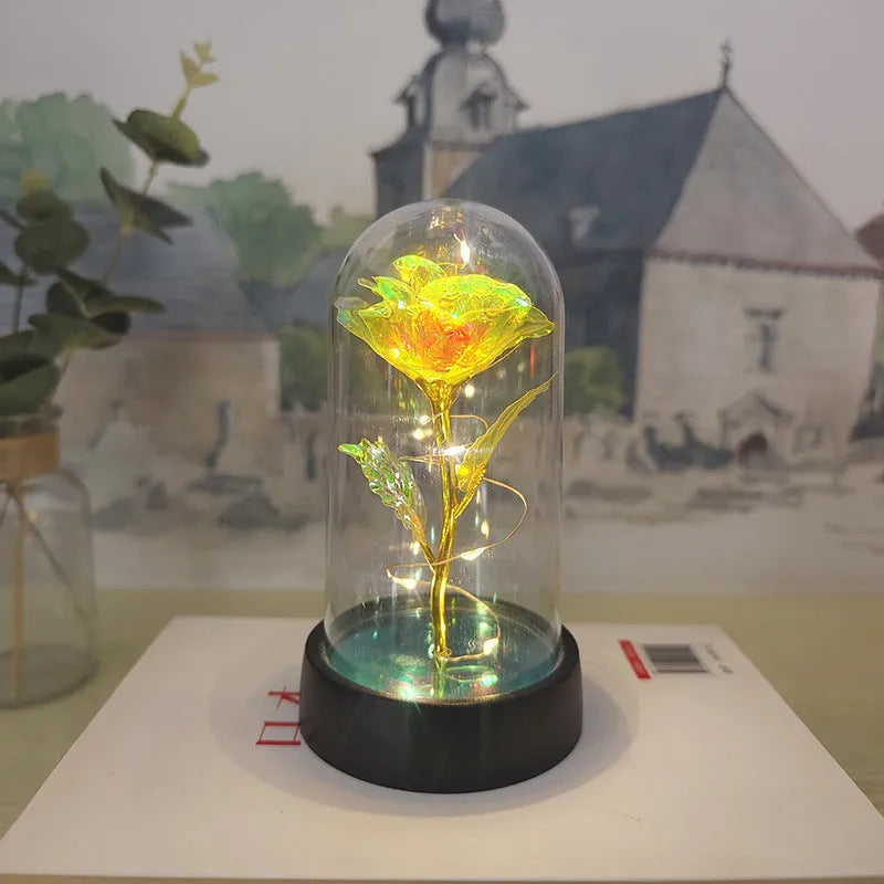 Small plastic night lamp with coloured LED lights and a decorative flower design under a glass-style cover.