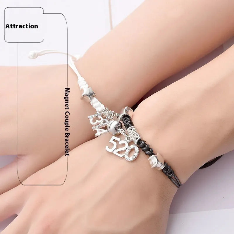 A pair of silver alloy bracelets with magnetic clasps and assorted charm designs including crowns, stars, and clovers.