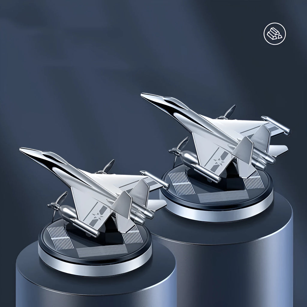 Solar powered rotating silver fighter aircraft perfume diffuser ornament on a car dashboard.