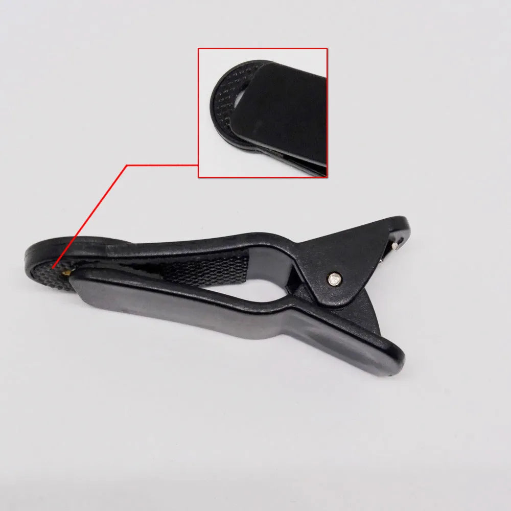 12x telescopic smartphone lens with a universal metal clip attached, shown next to a mobile phone.