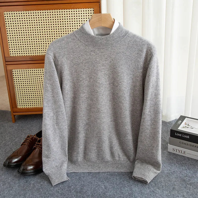 Man wearing a loose-fit half-collar wool sweater in a neutral colour, showing the knit texture and regular sleeve design.