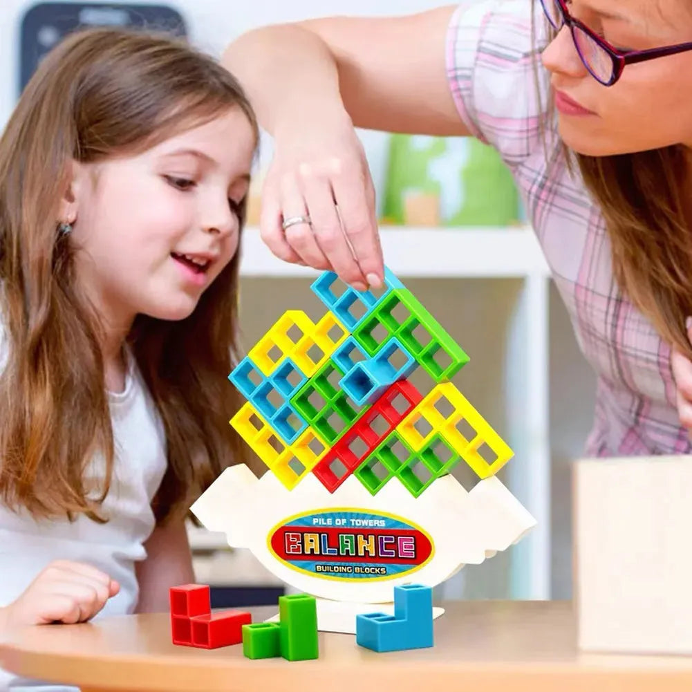 Plastic balance stacking game with 16 coloured blocks, chassis and base on a table