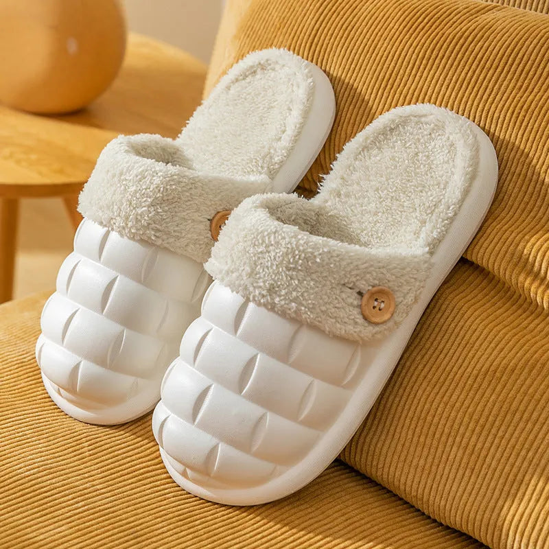 Pink and grey detachable EVA house slippers with plush lining and non-slip sole on a wooden floor.