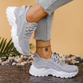 Women's low-top flyknit-style mesh casual trainers in various colours on a white background.