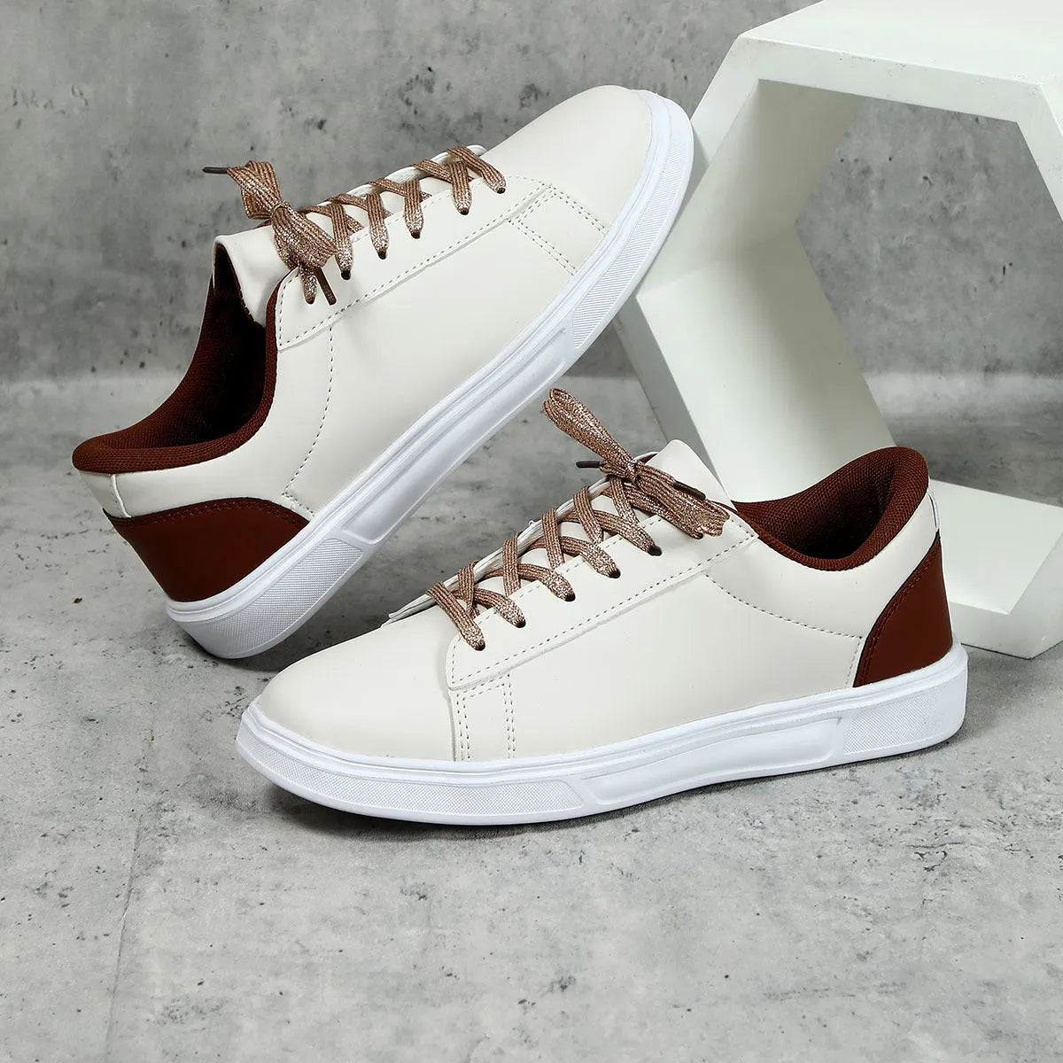Beige brown platform casual sneaker with cross-belt detail and a low-top silhouette on a white background.