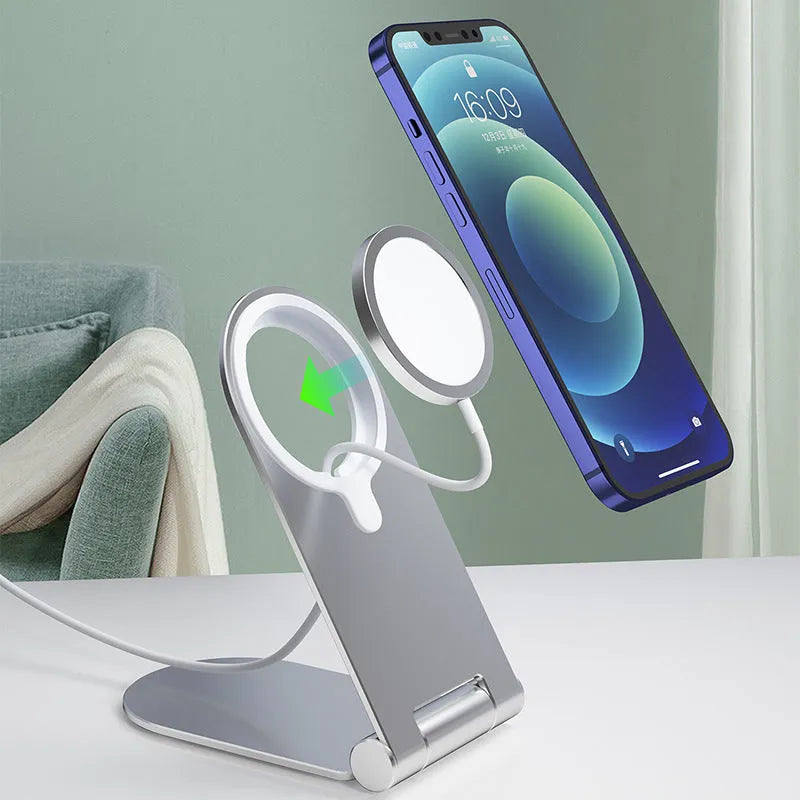 Silver vertical adjustable magnetic phone bracket for iPhone 12 models on a flat surface.