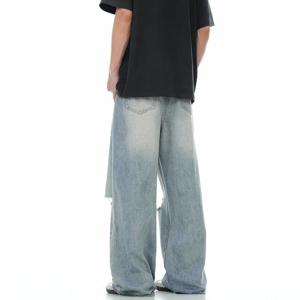 Blue men's retro straight-leg jeans with ripped details and a zipper fly.