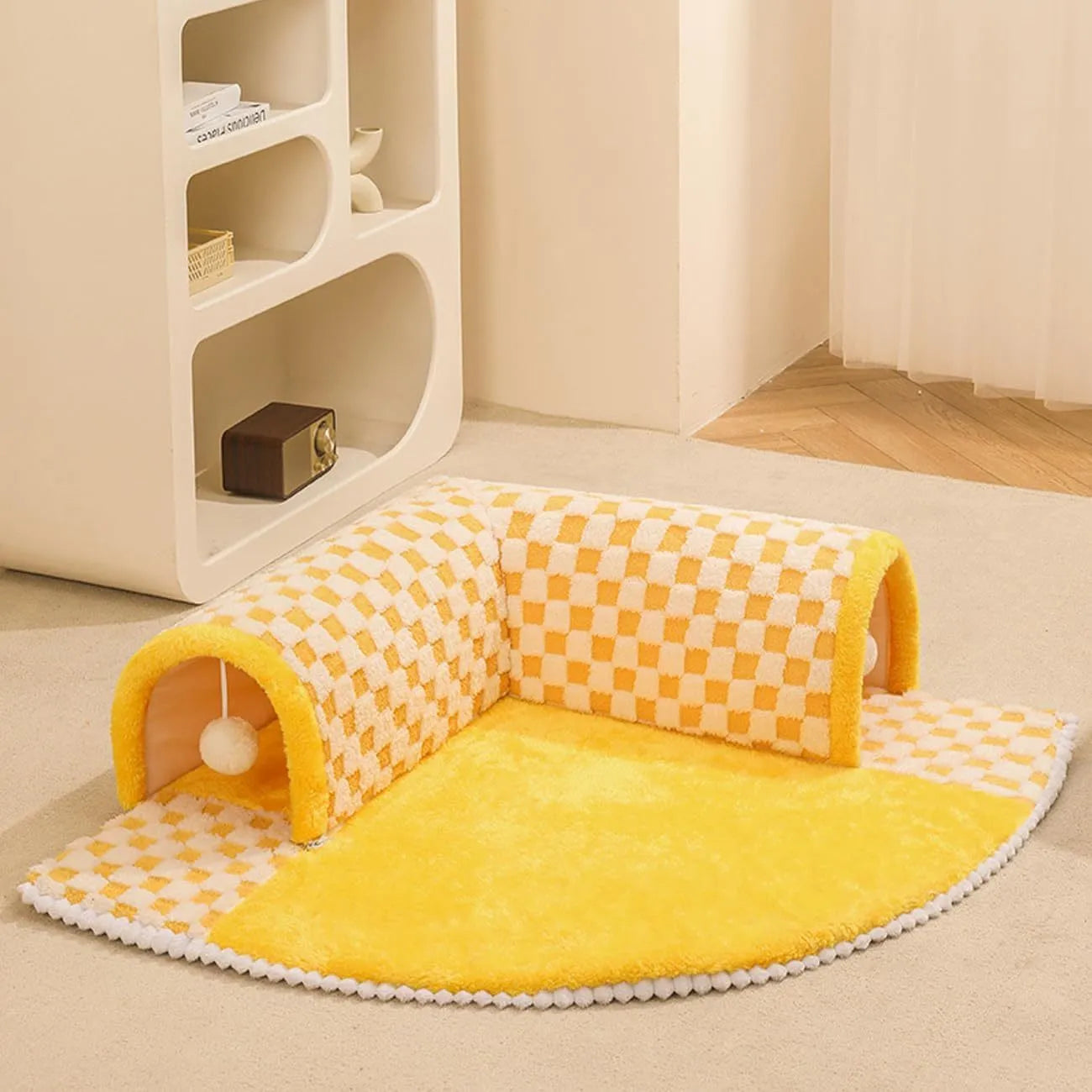 Coffee-coloured plush pet bed with attached tunnel showing soft sleeping area and play space