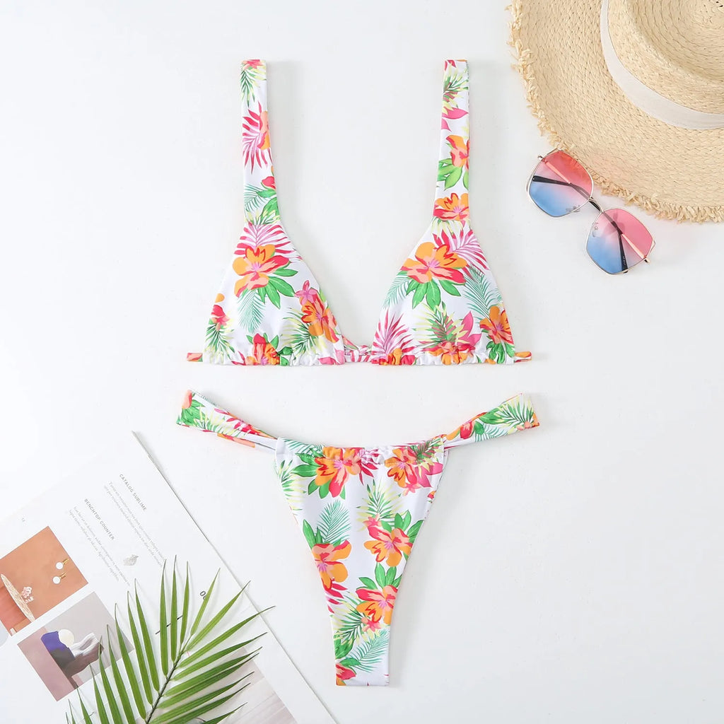 Women's floral print bikini swimsuit in blue, rose red, sky blue, or white, showing bra and briefs style panties.