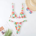 Women's floral print bikini swimsuit in blue, rose red, sky blue, or white, showing bra and briefs style panties.
