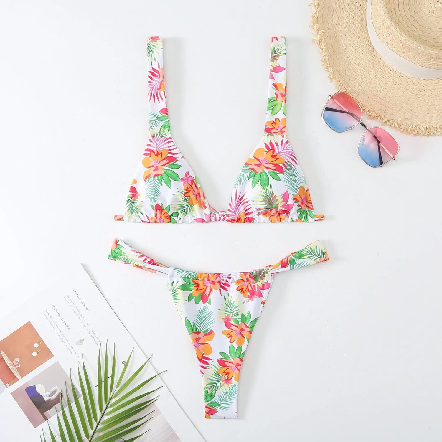 Women's floral print bikini swimsuit in blue, rose red, sky blue, or white, showing bra and briefs style panties.
