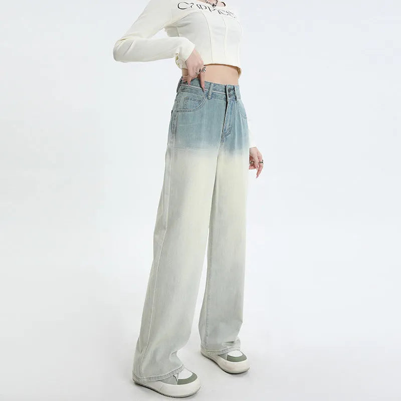 A pair of women's gradient blue straight-leg denim trousers with a wide leg opening, laid flat.