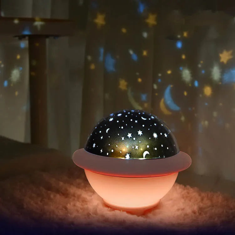 Green UFO-shaped night light projecting a starry sky pattern onto a surface, showing its modern plastic design.