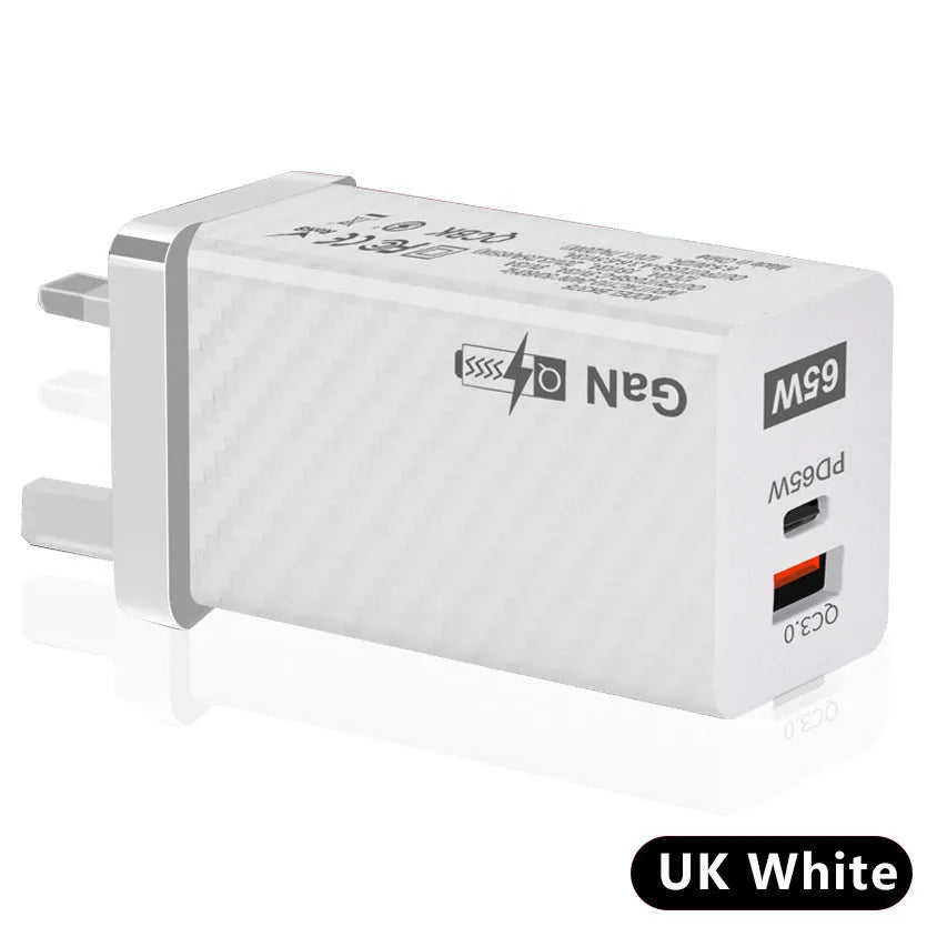 Black and white Gallium Nitride 65W USB-C laptop charger with EU, UK, and US plug options shown next to a laptop.