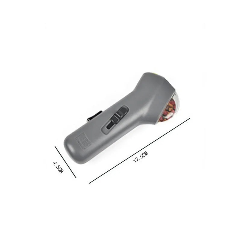 Grey plastic pet treat launcher measuring 18cm long with spring trigger for dog and cat training