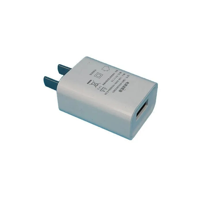 White standard power adapter with CE FCC marks and USB port for 5V charging