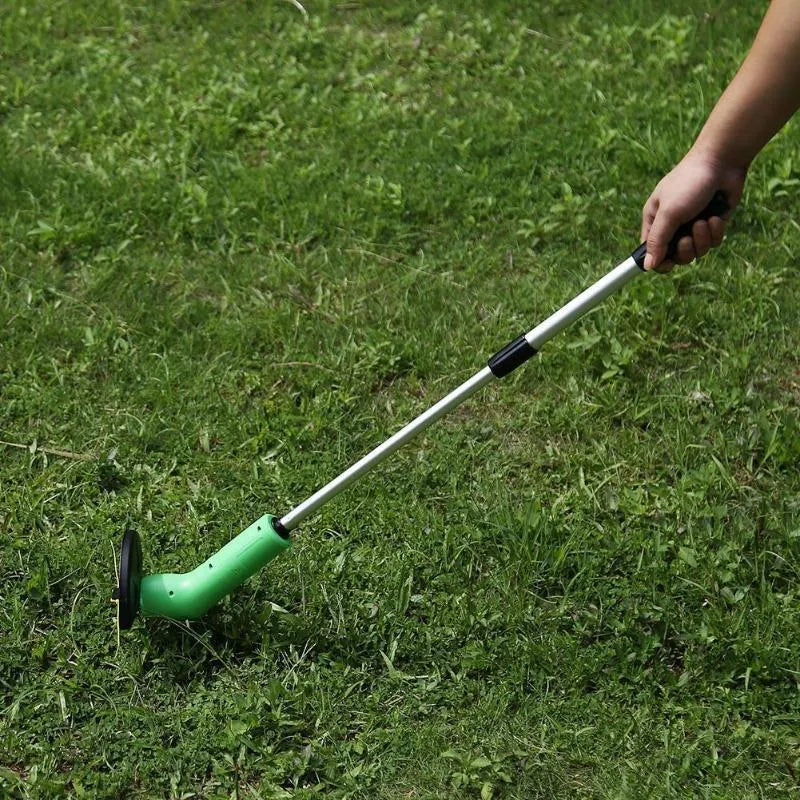Cordless handheld zip trimmer with extension pole and debris shield on grass