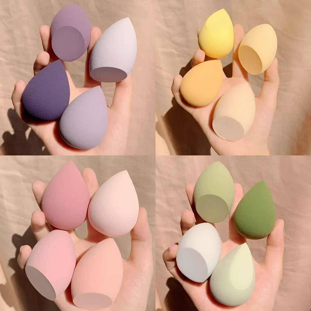 Set of four coloured makeup sponge eggs in grape, mango, mint, and peach peach, each measuring 6cm.