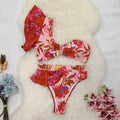 Women's pink one-shoulder ruffled bikini with high-waist briefs and red flower print