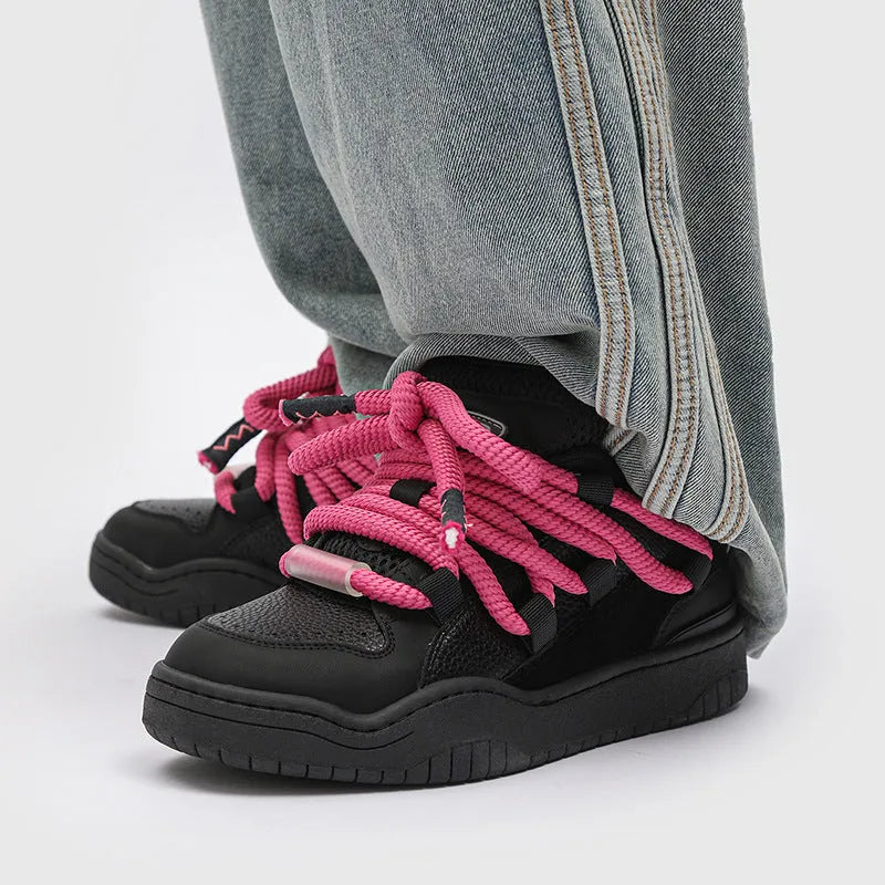 Pair of low-top unisex casual lace-up shoes with a thick rubber sole, shown in a solid colour.