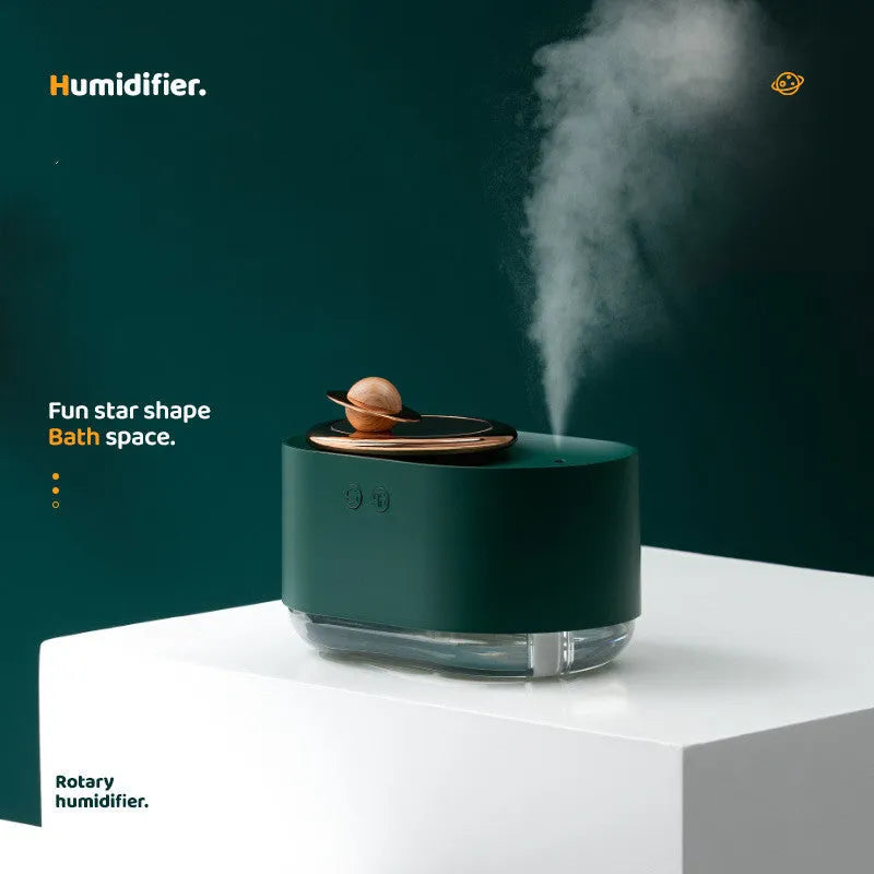 Green rotating planet-shaped USB humidifier with night light on wooden surface