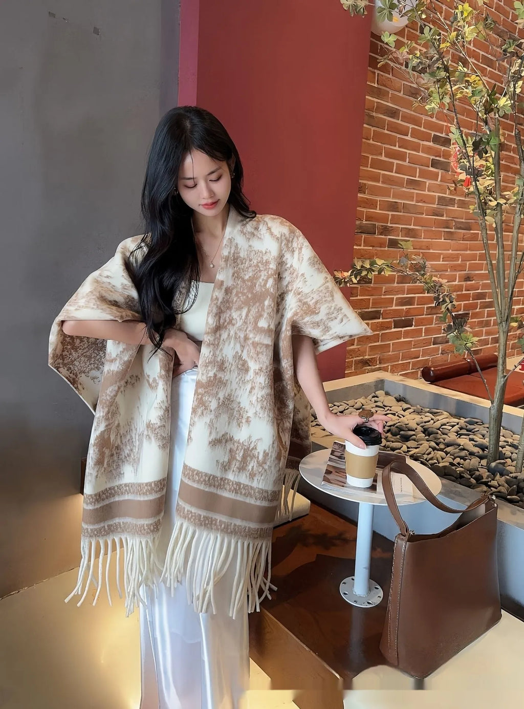 Women's polyester tassel scarf cape draped over shoulders in shawl style