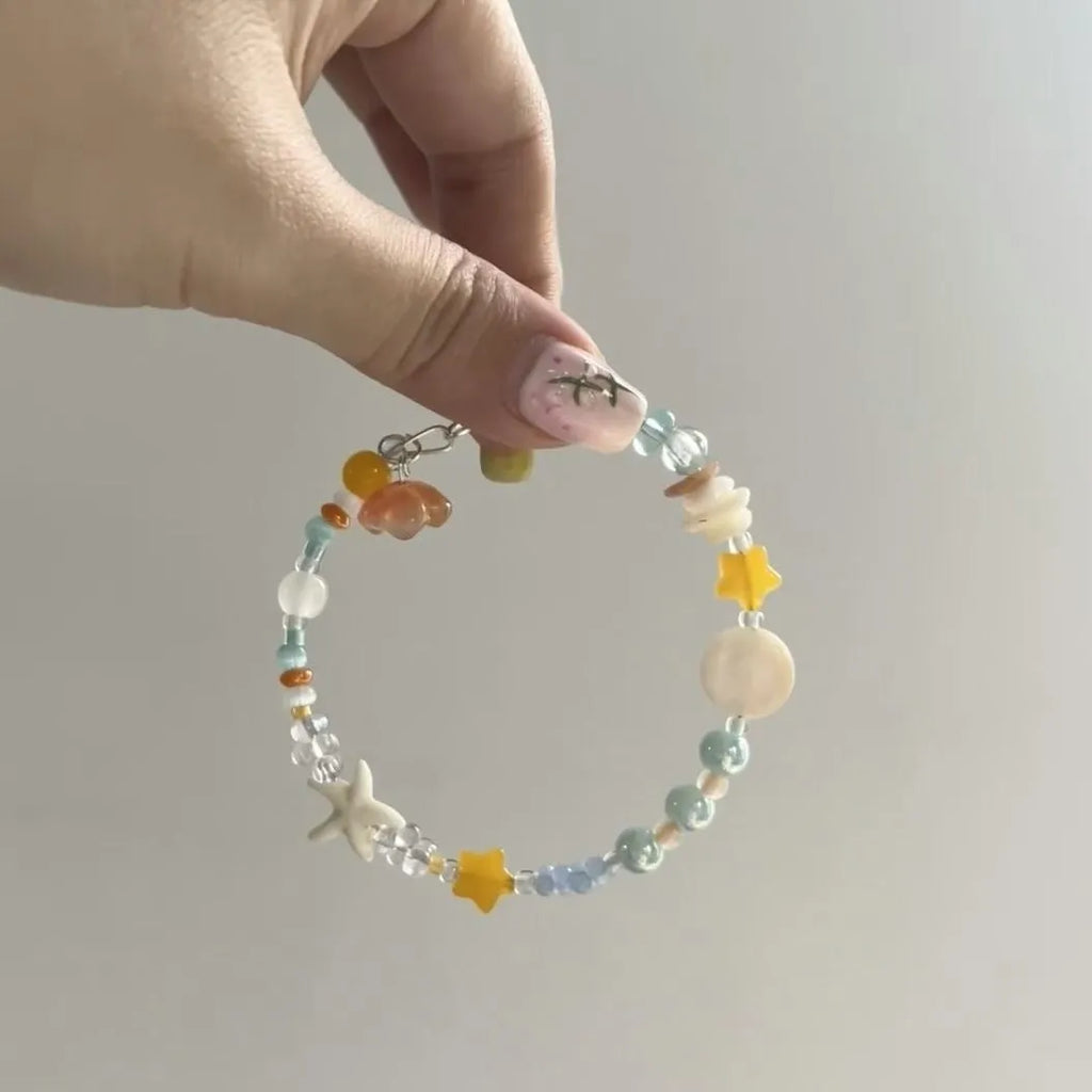 Orange alloy bracelet with diamond-shaped links and mixed material construction