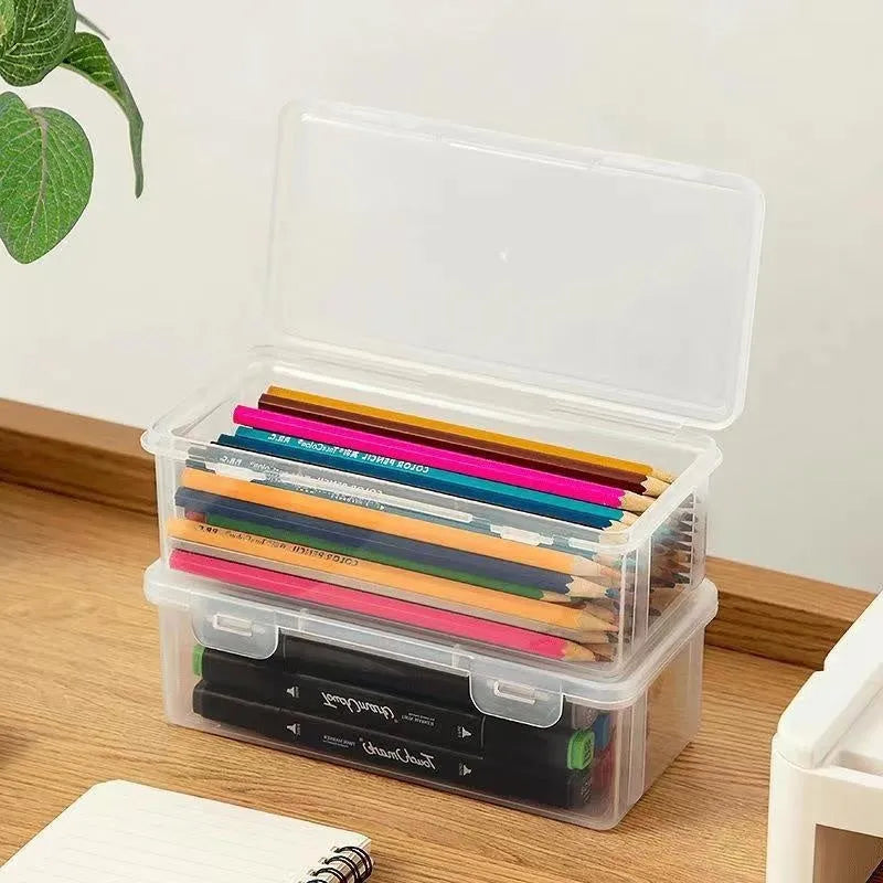 Transparent plastic stationery storage box showing pencils and art supplies inside