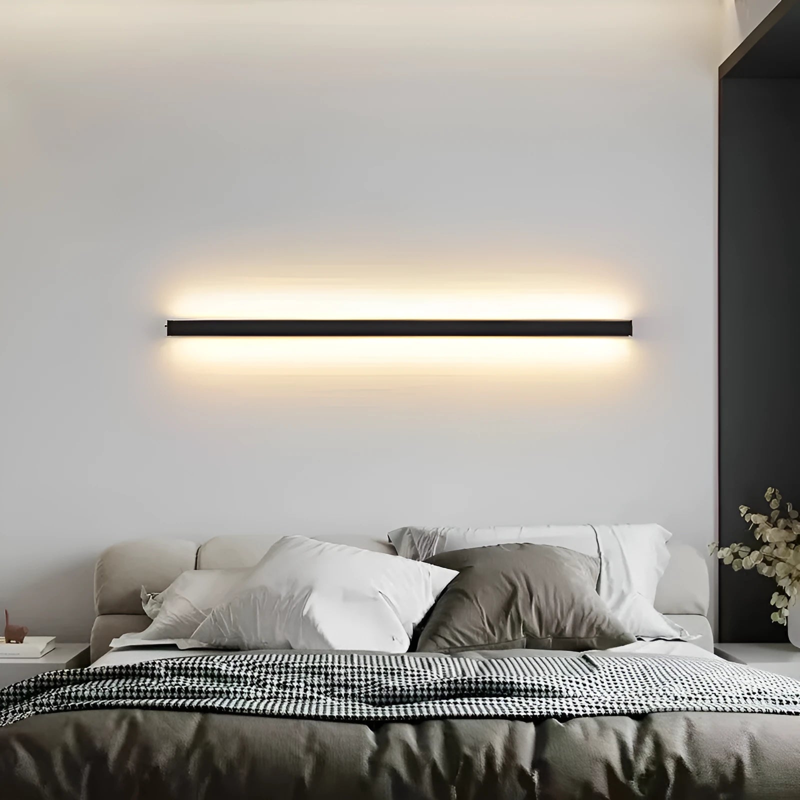 80 cm long black aluminium LED wall lamp with touch control for three light colours on a plain wall