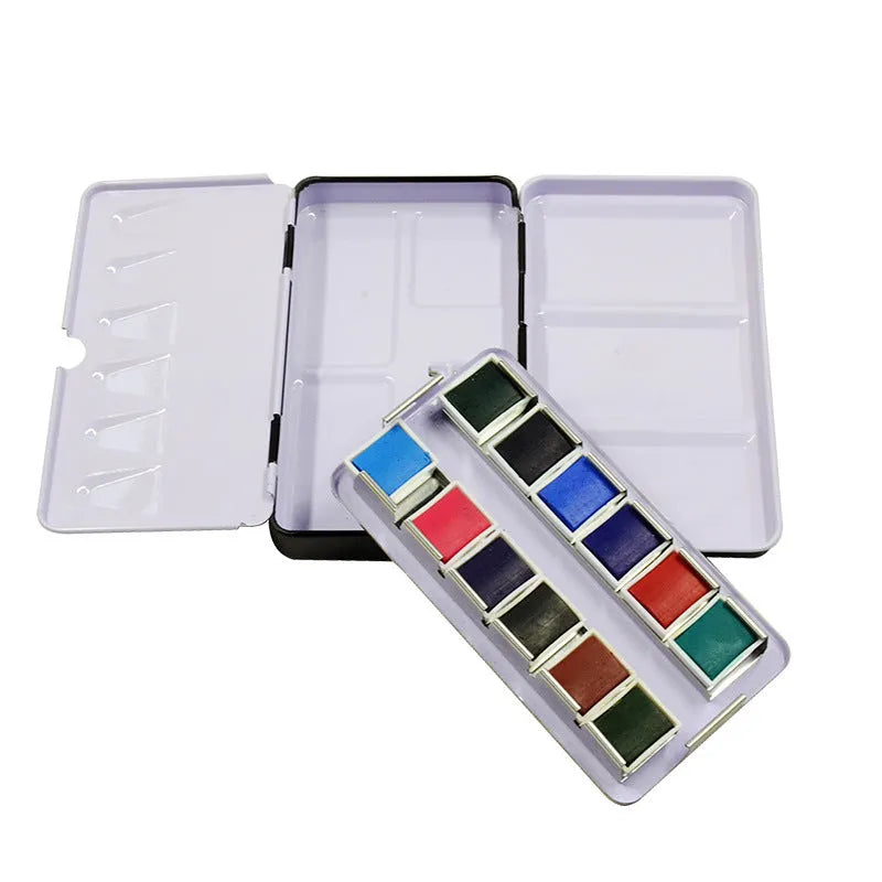 Solid tinplate paint box for watercolour pigments in a three-fold square design.